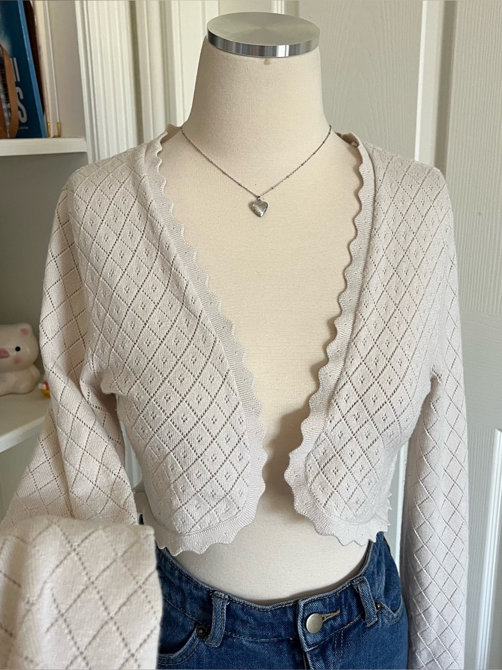 Beverly and Beck beige cropped cardigan with scalloped hem.